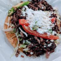 Tostada · Your choice of topping, lettuce, tomatoes, sour cream, cheese, and avocado.