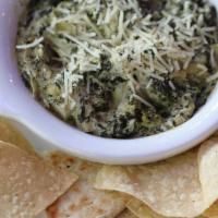 Spinach Artichoke Dip · Homemade to perfection, served with chips and pita bread