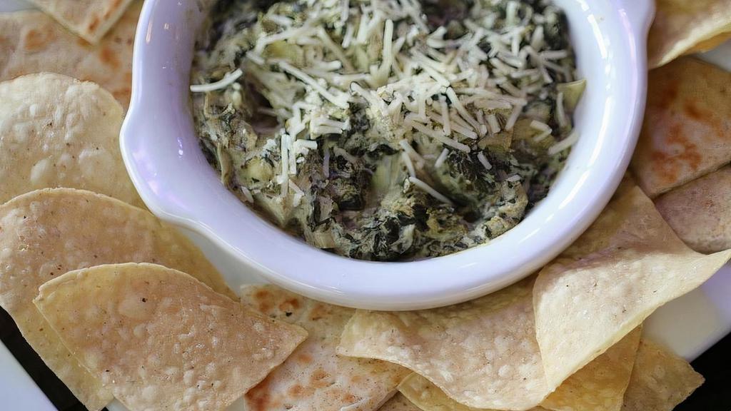 Spinach Artichoke Dip · Homemade to perfection, served with chips and pita bread
