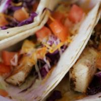 Mahi Tacos · Three soft shell tacos with strips of Mahi Mahi, cabbage, shredded cheese, tomatoes, & chipo...