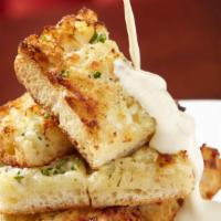 Signature Garlic Bread · Crispy ciabatta bread stacked and topped with our rich and creamy Roth käse blue cheese fond...