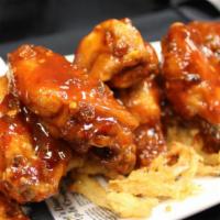 Craft House Wings · Our signature wings tossed in a sweet and spicy sauce.