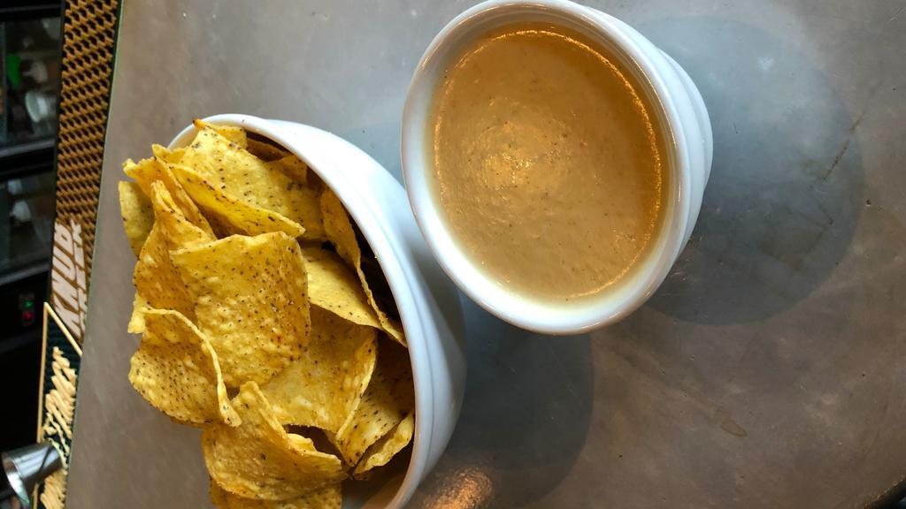 Queso & Chips · Blend of Oaxacan and Chihuahua Cheeses. All Latin cheese. Much lighter than a traditional American Queso dip.