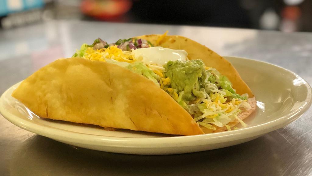 Taco Salad · Your choice of meat shredded beef, shredded chicken or ground beef. Served with rice, refried beans, lettuce, pico de gallo, Mix Cheese, Sour Cream and Guacamole.