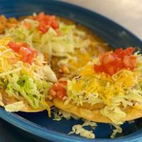 Two Bean Tostadas · Tostada serve with beans, lettuce, cheese, tomatoes