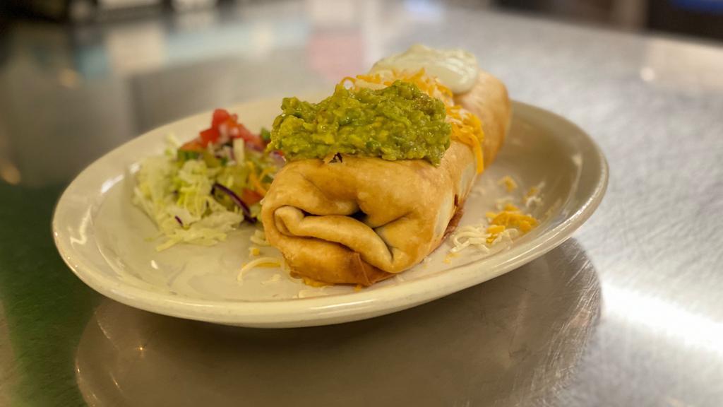 Chimichangas · Choice of meat asada, pork, shredded beef, shredded chicken or ground beef. On the inside beans and rice, served with lettuce, pico de gallo topped with sour cream, guacamole and cheese