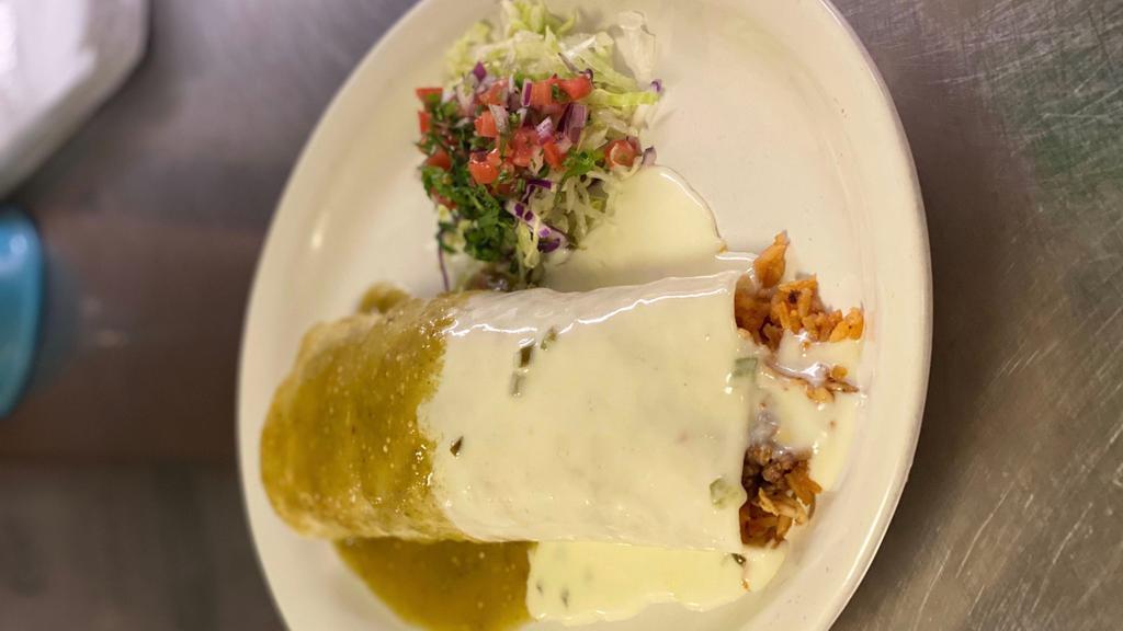 Rio Bravo Burrito · Filled with grilled chicken & asada, rice, cheese & topped with cheese sauce, and green sauce.