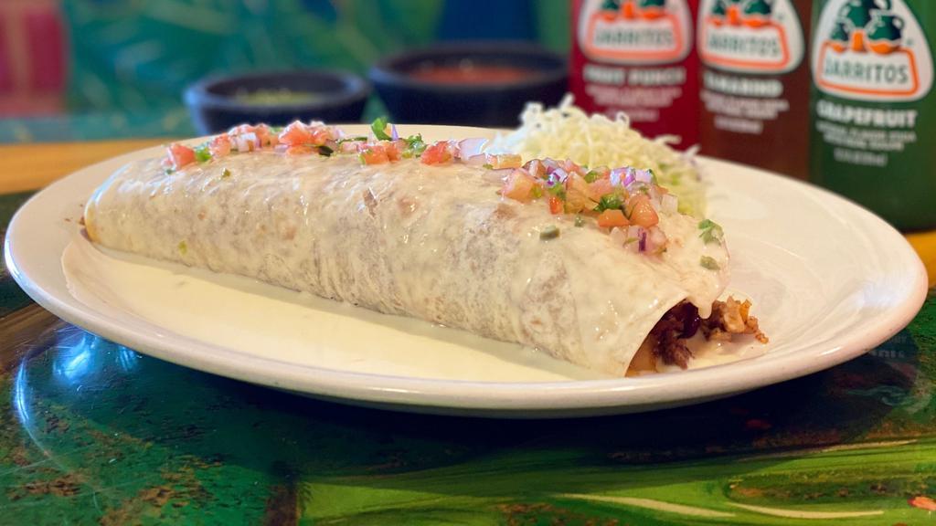 Pancho Burrito · Filled with chicken, chorizo, bacon and rice topped with cheese sauce and pico de gallo.