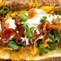 Harper’S Huge Loaded Potato (With Protein) · Topped with butter, cheese, sour cream, chives, bacon, & BBQ sauce.