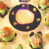 Volcano · Shrimp, tempura, cucumber and avocado wrapped in green soy pepper topped with spicy crunchy ...