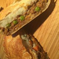 Shepherd'S Pie · Ground beef with sautéed onions in a rich thick gravy, peas, carrots, and mashed potatoes.