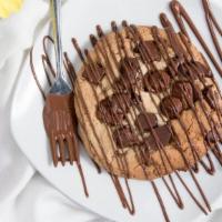Giant Chocolate Chip Cookie · Fresh baked daily.  Stuffed with chocolate chips and drizzled with chocolate.