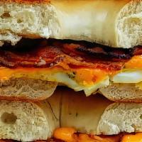 Bagel Sandwich · A New York style bagel (the best ever) with a scrambled egg, choice of meat and mild cheddar...