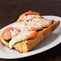 Garlic Bread Spinach And Tomato · Topped with melted mozzarella.