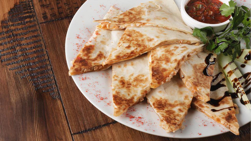 Beef Quesadilla · A blend of Oaxaca cheese, provolone and mozzarella, Mediterranean grilled skirt steak, grilled diced onions, and poblano peppers inside 7