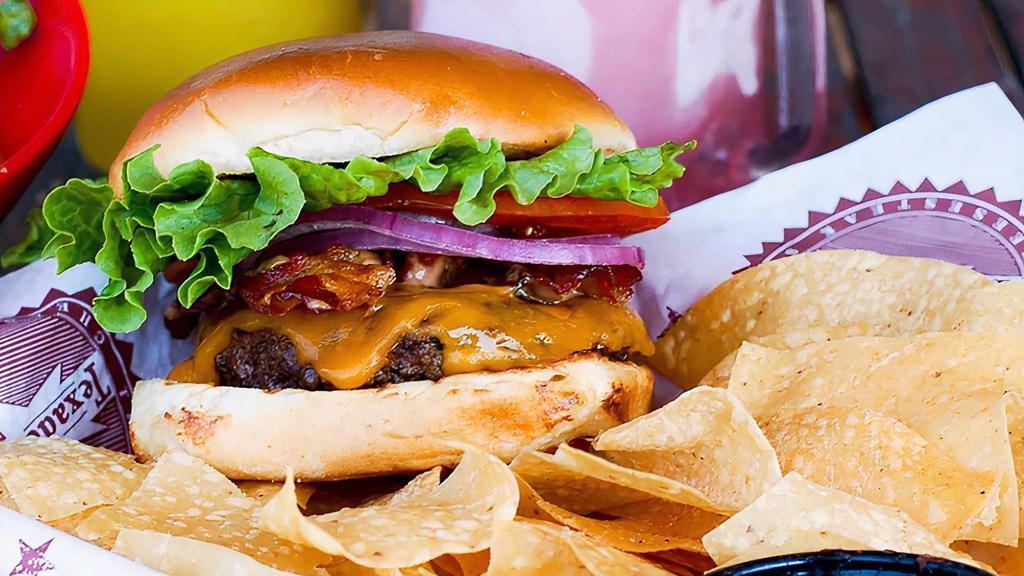 Hickory Ranch & Bacon Burger · Our 1/2 lb burger patty, topped with cheddar cheese, bacon, lettuce, tomato & onion.  Served with our creamy Hickory Ranch sauce.