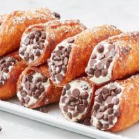 Mini Cannoli · Sweet, creamy Ricotta & chocolate chip filling, topped with nuts, in cannoli shell.