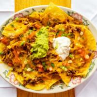 Nachos With Carnitas, Ground Beef, Chicken Or Beans. · Add lettuce, sour cream, and tomato for additional charge.