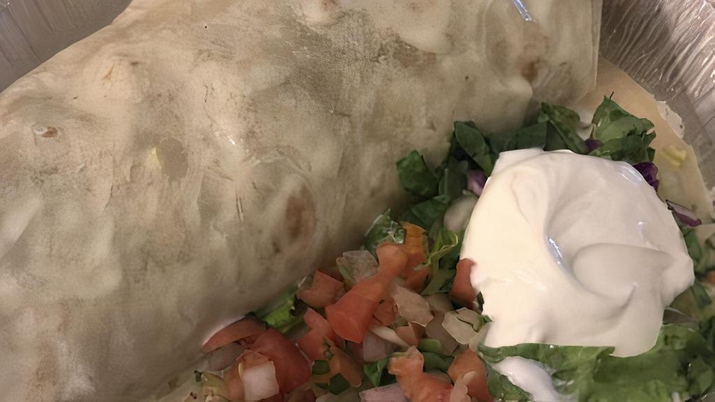 Burrito California · Extra large burrito filled with Mexican rice, fried beans and chicken or steak (sirloin steak), covered with cheese dip. Served with mixed salad, fresh guacamole, Pico de Gallo and sour cream.