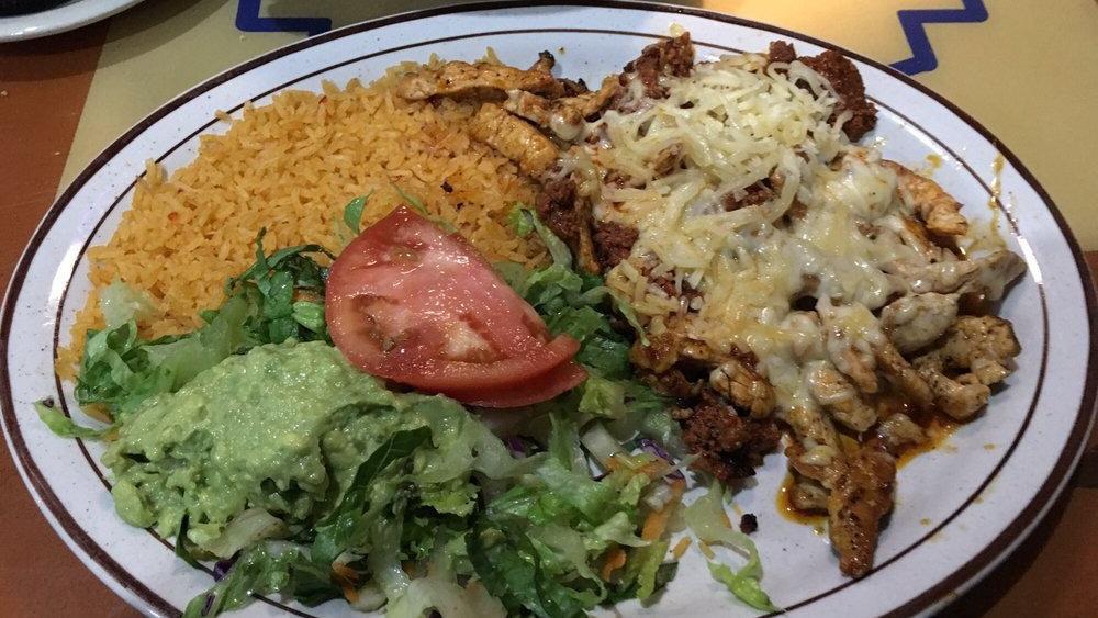 Chori Pollo · Grilled chicken strips topped with Mexican pork sausage and cheese. Served with Mexican rice, fresh guacamole, mixed salad and three flour tortillas.