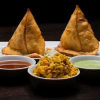 Chicken Keema Samosa · Deep fried triangular pastry filled with seasoned minced chicken and peas.