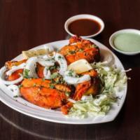Tandoori Chicken · Chicken marinated in yogurt with herbs and spices. Cooked in clay oven.