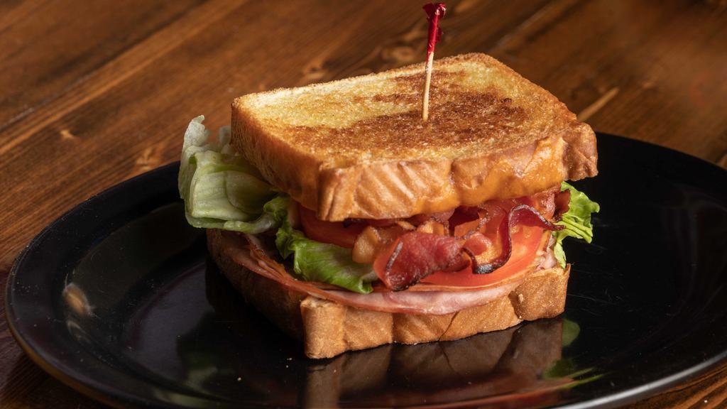 The Mug Club · A healthy portion of ham, turkey & bacon, cheddar cheese, lettuce, tomato & mayo, served on texas toast.