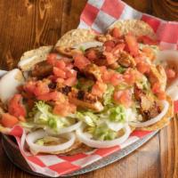 Chicken Loaded Nachos · Smothered in white queso, diced onion, lettuce, tomato & topped with fajita chicken, sour cr...