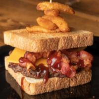 The Texan · Cheddar cheese, bacon, BBQ, onion petals served on texas toast.