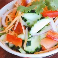 Cucumber Salad · Vegan and Gluten-Free. Chopped cucumber, onion, cilantro, carrot, tomato, and sweet vinaigre...