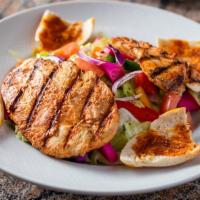 Grilled Chicken Salad · Grilled chicken, twice marinated with our special seasoning over a medley salad with our hom...