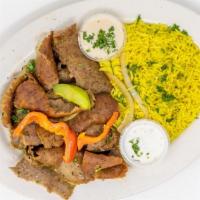 18) Gyro Plate · Roasted strips of gyro meat with the option of hummus, house salad, and Rice. Served with Pi...