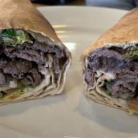 Beef Shawarma Wrap · Slices of seasoned beef, lettuce, tomatoes, onions, and Mediterranean pickles. Topped with t...