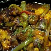 Sloppy Steak Bites · Diced beef tenderloin tips sautéed with peppers and onions over yellow rice with bourbon gla...