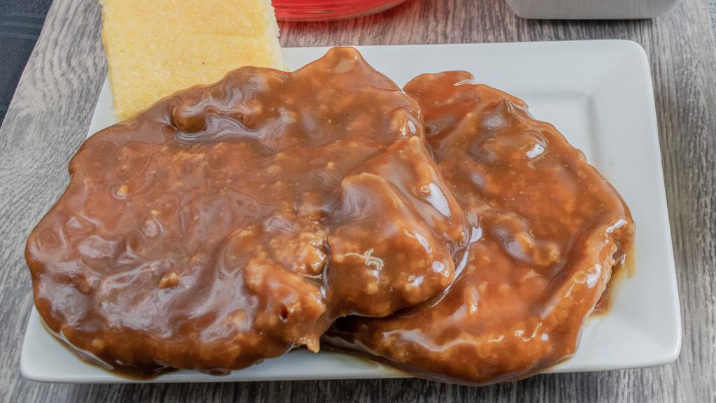 Smothered Pork Chop (1 Piece) · Fried golden brown and delicious pork chops in our special house recipe flour breading mix, then smothered in a classic brown gravy.