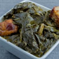 Collard Greens · Collard greens simmered to perfection with smoked turkey in our savory house recipe.