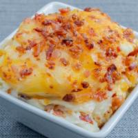 Loaded Mashed Potatoes  · We start with buttered mashed potatoes topped with our house blend of cheeses and crisp bacon.
