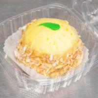 Key Lime Cake Bomb · Delicious Key Lime Cake with lime filling and lime icing, topped with shaved sweet coconut.