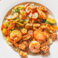 Combo Chicken & Shrimp Stir Fry · With stir fry sautéed vegetables on a bed of rice.