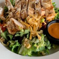 Southwest Chicken Salad · Lettuce blend topped with grilled chicken, cheddar cheese, black beans, corn, tomatoes, gree...