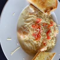 Lemon Garlic Shrimp Pasta · House made lemon garlic cream sauce over pasta with shrimp.  Served with Garlic Bread.