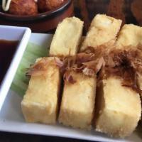 Agedashi Tofu · Lightly battered and deep fried tofu with seasoned soy sauce and grated giver and bonito.