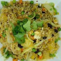 Pineapple Fried Rice · Rice fried with pineapple, egg, onion, sweet peas, carrots, raisins and cilantro. Can be mad...