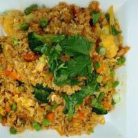 Curry Fried Rice · Rice fried with yellow curry powder, egg, onion, carrots, sweet peas and cilantro. Can be ma...
