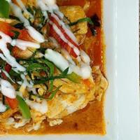Panang Curry · Panang curry paste and bell peppers in coconut milk with fresh kaffir lime leaves served wit...