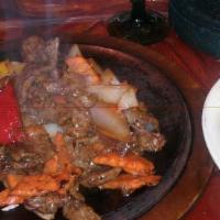 Steak Fajitas · Marinated steak sautéed with onions, bell peppers, carrots, pico de gallo, and guacamole.