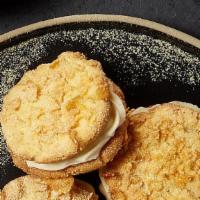 Cornflake Cream Pie · 2 cornflake cookies sandwiched together with honey cream cheese icing. Contains Space Corn.