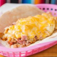 Ham, Egg And Cheese Breakfast Taco · Ham, scrambled egg and cheese served on flour tortillas.