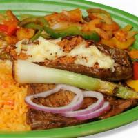 Bistec Ranchero · Tender rib-eye Steak grilled with onions, tomatoes, bell peppers and a banana pepper filled ...