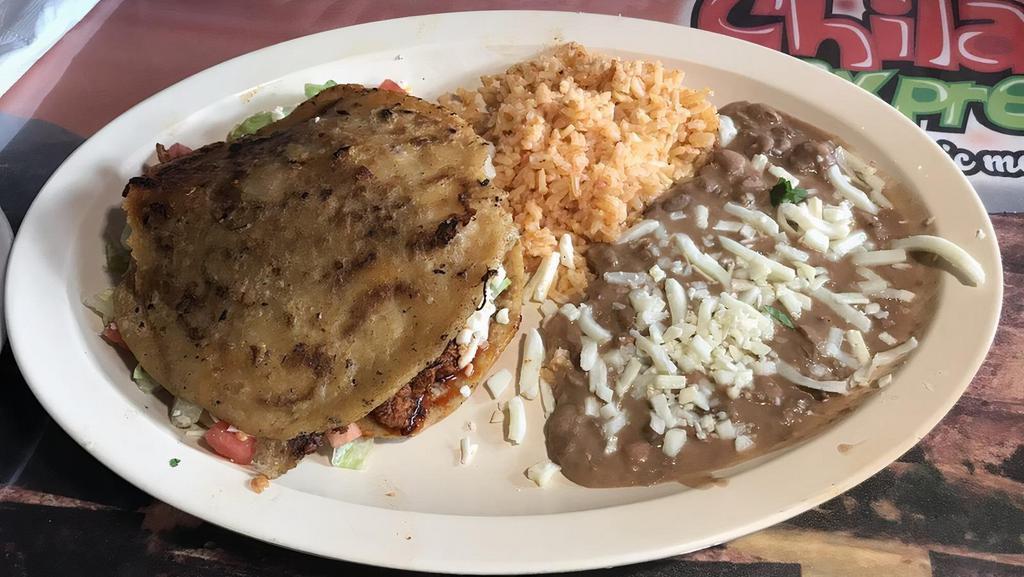 Gordita Dinner · Extra large thick deep fried corn tortilla stuffed with your meat or vegetable choice, lettuce, tomato, cheese and sour cream. Served with rice and beans.
